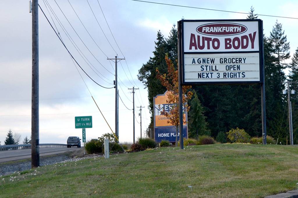 To encourage more business, Chris Frankfurth, owner of Frankfurth Auto Body on U.S. Highway 101, setup his sign to encourage visitors to his other business Agnew Grocery following the closure of the McDonald Creek Bridge for construction. Matthew Nash/Olympic Peninsula News Group
