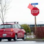A driver turns right at a stop sign in Port Townsend. City crews removed signage from signs that allowed drivers to turn right at stop signs without stopping. (Jesse Major/Peninsula Daily News)