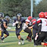 Lonnie Archibald/for Peninsula Daily News Forks Cole Baysinger eyes a running lane during a win over Neah Bay. Baysinger was an electrifying force for Forks and is the 2017 All-Peninsula Football MVP.