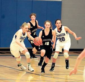 Steve Mullensky/for Peninsula Daily News Quilcenes Brittney Beukes drives down court with Chimacums Grace Yaley and Mia McNair close on her heels during a Thursday night game in Chimacum.