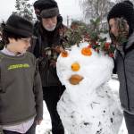 Oscar, Michael and Ruth Levine of Walker Street, Port Townsend, created a snowman for their neighbors as a Christmas surprise.They used volunteer plant material, repurposed Halloween mini-pumpkins, a squash and bread for lips. The project started out as a snowball fight and grew from there. (Jeannie McMacken for Peninsula Daily News).