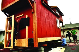 Peninsula College student carpenters work  on finishing the exterior of the mini-home they are building at the Lincoln Center in Port Angeles. Jesse Major/for Peninsula Daily News
