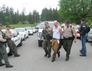 Patrick B. Drum is led off by authorities following his capture following a 3.5-hour manhunt Sunday afternoon. Clallam County Sheriff's Office