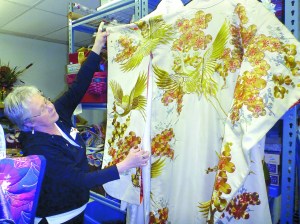 Sue Garlinghouse shows off the wedding kimono donated by Jeannette Hall of Quilcene. Jennifer Jackson/for Peninsula Daily News