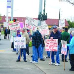 More than 30 MoveOn.org supporters from Sequim and Port Angeles gather at the intersection of Washington Street and Sequim Avenue late Tuesday afternoon for a “Tax Day” protest. The message of the group led by Andrea Radich of Port Angeles — to tax the 1 percent and spare the 99 percent — echoed similar protests across the nation. Jeff Chew/Peninsula Daily News