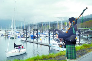 Bagpiper Nancy Fredrick of Port Townsend plays from the point overlooking the entrance to John Wayne Marina in Sequim to celebrate the opening day of boating season in 2011. Keith Thorpe/Peninsula Daily News