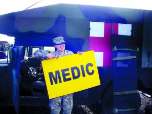 Kristin Kartak beside a military ambulance during a routine training mission.