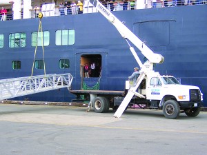 Boom truck operator Mike Boogaard of Straits Marine & Industrial of Port Angeles maneuvers the gangway to the ms Oosterdam at the Port of Port Angeles Terminal 1 North on Wednesday.  -- Photo by David G. Sellars/for Peninsula Daily News