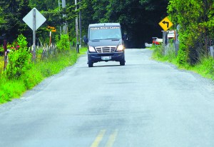 An Elwha River Casino shuttle bus makes its way down a wavy stretch of Lower Elwha Road near the Lower Elwha Klallam reservation. -- Photo by Keith Thorpe/Peninsula Daily News