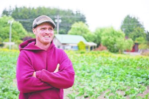 Patrick Drum stands in a Nashs Organic Produce field