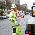 Tim Childs, traffic control supervisor for Interwest Construction in Carlsborg, places no parking signs along Water Street in downtown Port Townsend on Friday. On Tuesday, the company will start a project that includes replacing sewer lines and placing power lines underground. (Steve Mullensky/for Peninsula Daily News)