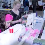 MiAmada Lamphear, 12, and Katie Bailey, 19  who was on break from classes at Idaho State University  put their sewing skills to work for the sake of animals. Their work helped create pet beds for local animal shelters during a volunteer afternoon in Port Hadlock. (Jeannie McMacken/for Peninsula Daily News)