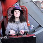 Tallulah Sebastian of Port Townsend, daughter of Gus Sebastian of Olympic Boat Transport & Crane, works the controls on her fathers crane truck Sunday, positioning the boom that holds the anchor for the anchor raising in Port Townsends First Night celebration. (Jeannie McMacken/for Peninsula Daily News)