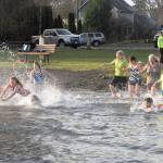 More than a dozen people entered the chilly waters of Lake Pleasant on Monday morning for the polar bear plunge. (Lonnie Archibald/for Peninsula Daily News)