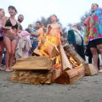 Swimmers warm up after taking a dip in the Strait of Juan de Fuca during the annual Polar Bear Dip at Hollywood Beach in Port Angeles on Monday. (Jesse Major/Peninsula Daily News)