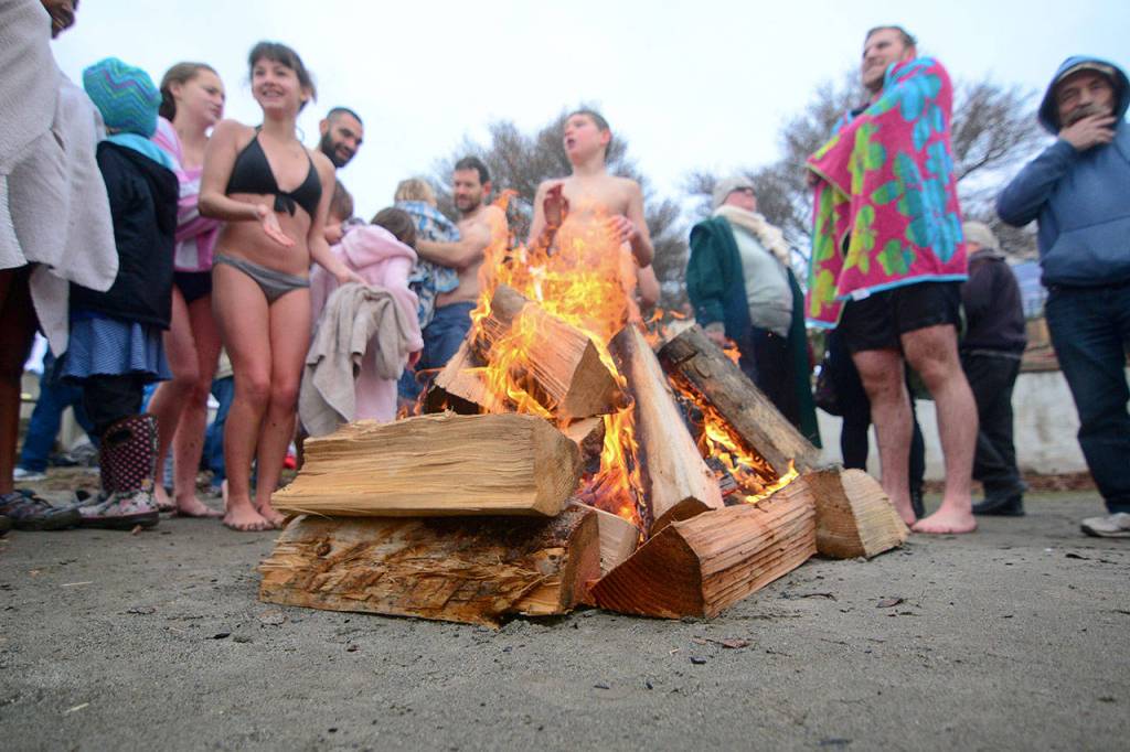 Swimmers warm up after taking a dip in the Strait of Juan de Fuca during the annual Polar Bear Dip at Hollywood Beach in Port Angeles on Monday. (Jesse Major/Peninsula Daily News)