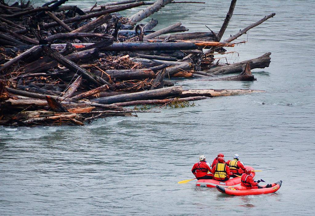 Search and rescue workers make their way down the Elwha River on Monday. (Jay Cline/Clallam County Fire District No. 2)