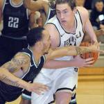 Keith Thorpe/Peninsula Daily News Peninsulas Marky Adams, right, fends of the defense of Shorelines Darnell Berry on Wednesday in Port Angeles.