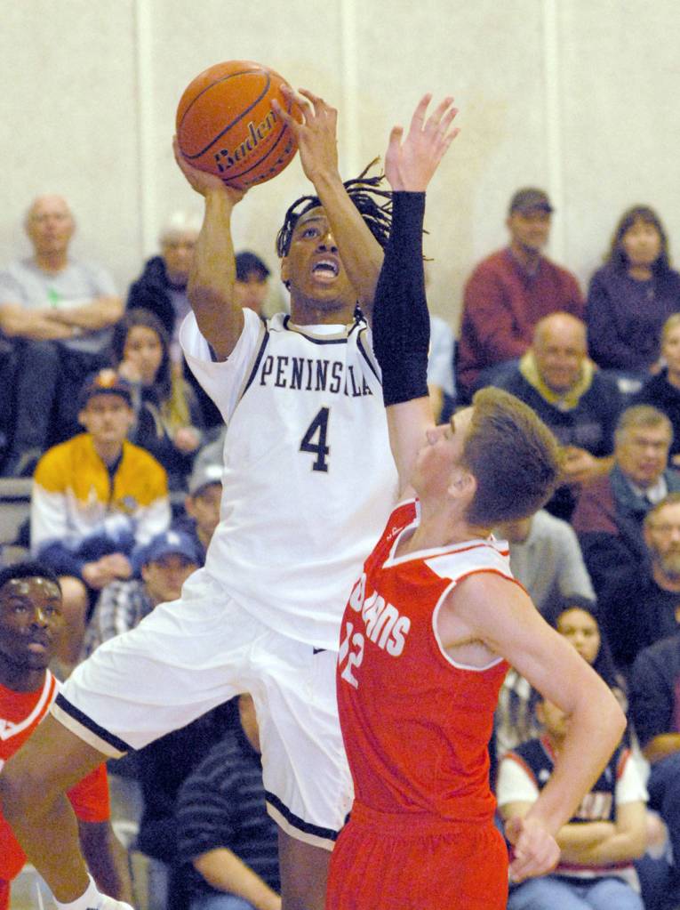 Keith Thorpe/Peninsula Daily News Peninsulas Kaelin Crane, left, shoots from the lane as Everetts Bryson Kelley defends in the first half on Saturday on the Pirate home court in Port Angeles.