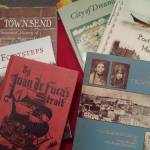 A collection of Port Townsend history books, including the work of May Smith, James McCurdy and Tom Camfield. (Linnea Patrick/for Peninsula Daily News)