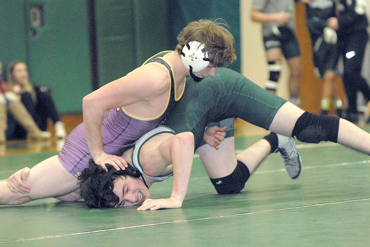 <strong>Keith Thorpe</strong>/Peninsula Daily News                                Sequims Ben Newell, top, holds down Port Angeles Jackson Larson in the 152 weight class during Thursday nights Battle For the Axe at Port Angeles High School.