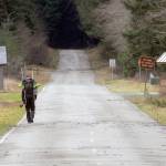 A lone hiker walks up Olympic Hot Springs Road in Olympic National Park on Saturday. Although the road had been previously barricaded because of storm damage, the park was officially closed on Saturday as a result of a federal government shutdown, but many areas remained accessible. (Keith Thorpe/Peninsula Daily News)