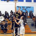 Lonnie Archibald/for Peninsula Daily News                                Forks Braton Armas (23) scores over Elmas Carter Jacobson Friday night in Elma. Forks beat the Eagles 65-46 to go to 5-0 in the Evergreen 1A League.