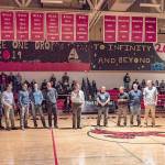 Players, coaches and cheerleaders from the 1992-93 Port Townsend basketball team are honored for their achievement 25 years after taking second at the Class A state tournament during halftime of a game between the Redhawks and the Klahowya Eagles on Friday. (Steve Mullensky/for Peninsula Daily News)
