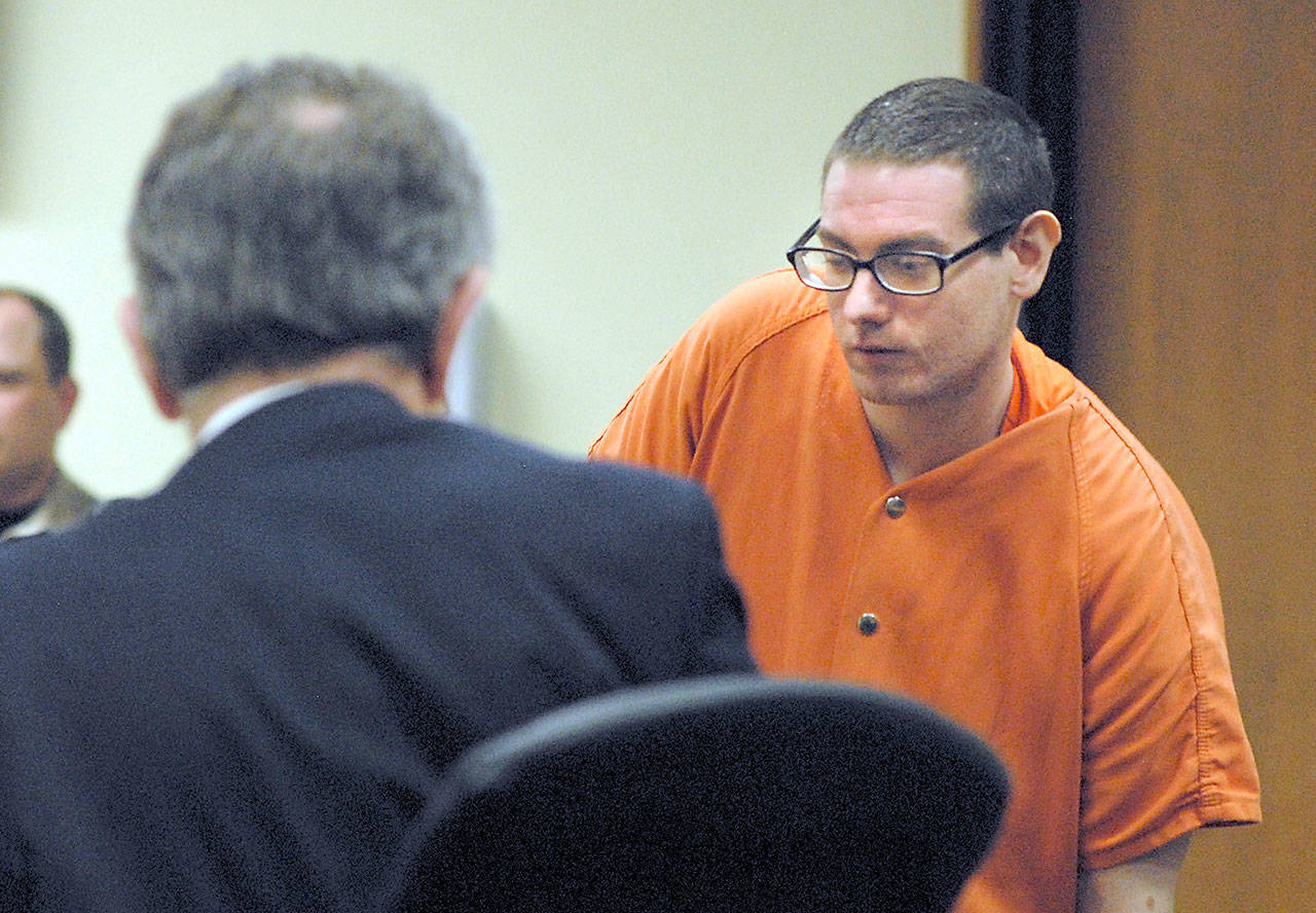 Donald William Kingsley of Port Angeles, right, returns to his seat next to attorney John Hayden after testifying in his own defense in Clallam County Superior Court on Tuesday in Port Angeles. (Keith Thorpe/Peninsula Daily News)