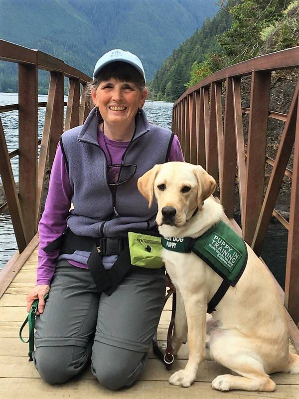 Puppy Pilots raisers like Deb Cox, seen here with Vanya, train a puppy from 8-10 weeks old up to 16 months old before Guide Dog officials further train them in Boring, Ore., in a five-month, 10-phase program that tests the dogs awareness to more complicated environments and circumstances. (Puppy Pilots)