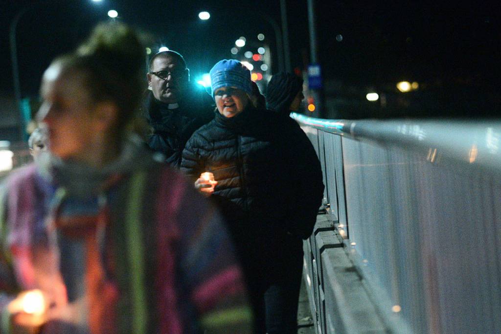 Dozens carrying candles walked the span of the Valley Creak Eighth Street Bridge in Port Angeles Wednesday during a vigil mourning community members who have committed suicide. (Jesse Major/Peninsula Daily News)
