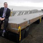 Port Angeles Parks and Recreation Department Director Corey Delikat sits on a floating dock section expected to be installed at Port Angeles City Pier this spring. New dock sections and a new gangway are currently being stored on Ediz Hook. (Keith Thorpe/Peninsula Daily News)