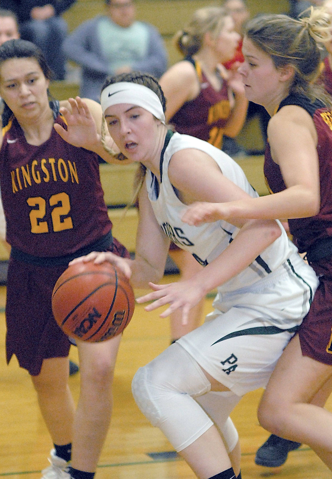 Keith Thorpe/Peninsula Daily News Port Angeles Devin Edwards, center, tries to escape the defense of Kingstons Karliegh Gomez, left, and Avy Hiner during a game earlier this season.