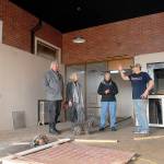 Port Angeles artists, from left, Bob Stokes, Cindy Elstrom and Mary Alice Long examine the space that will house the new Harbor Arts collective with building landlord John Hammond on Friday. The storefront at 114 N. Laurel St., in downtown Port Angeles will replace the Railroad Avenue building currently used for Harbor Arts in light of plans for a hotel by the Lower Elwha Klallam Tribe. (Keith Thorpe/Peninsula Daily News)