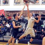 Forks Braton Armas, right, scores around Seton Catholics Hayden Miller during the Spartans Southwest District 4 playoff game in Forks on Friday. (Lonnie Archibald/for Peninsula Daily News)