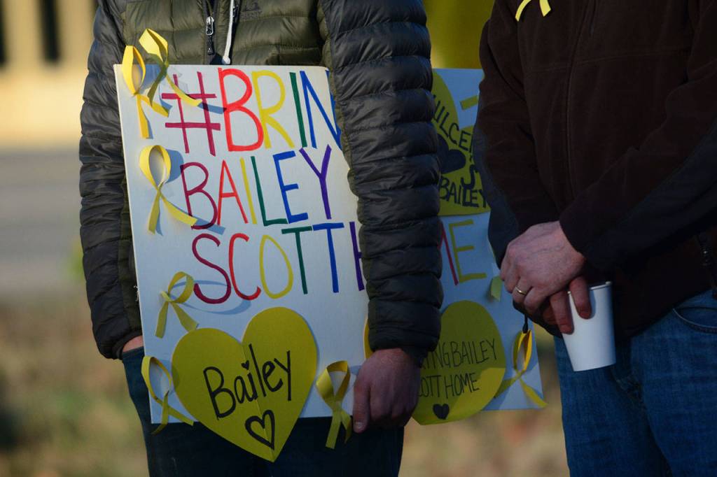 Many who attended the rally for missing 16-year-old Bailey Scott carried signs Sunday in Quilcene. (Jesse Major/Peninsula Daily News)