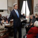 Former Secretary of State John Kerry greets members of the House Democratic Caucus on Tuesday during a visit hosted by Gov. Jay Inslee to participate in meetings discussing the governors proposed tax on fossil fuel emissions. (Ted S. Warren/The Associated Press)
