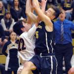 Keith Thorpe/Peninsula Daily News Neah Bays Captain Claplanhoo, right, tangles with Tacoma Baptists P.J. Talen while fighting for a rebound in the second quarter of their district playoff game on Tuesday night in Port Angeles.