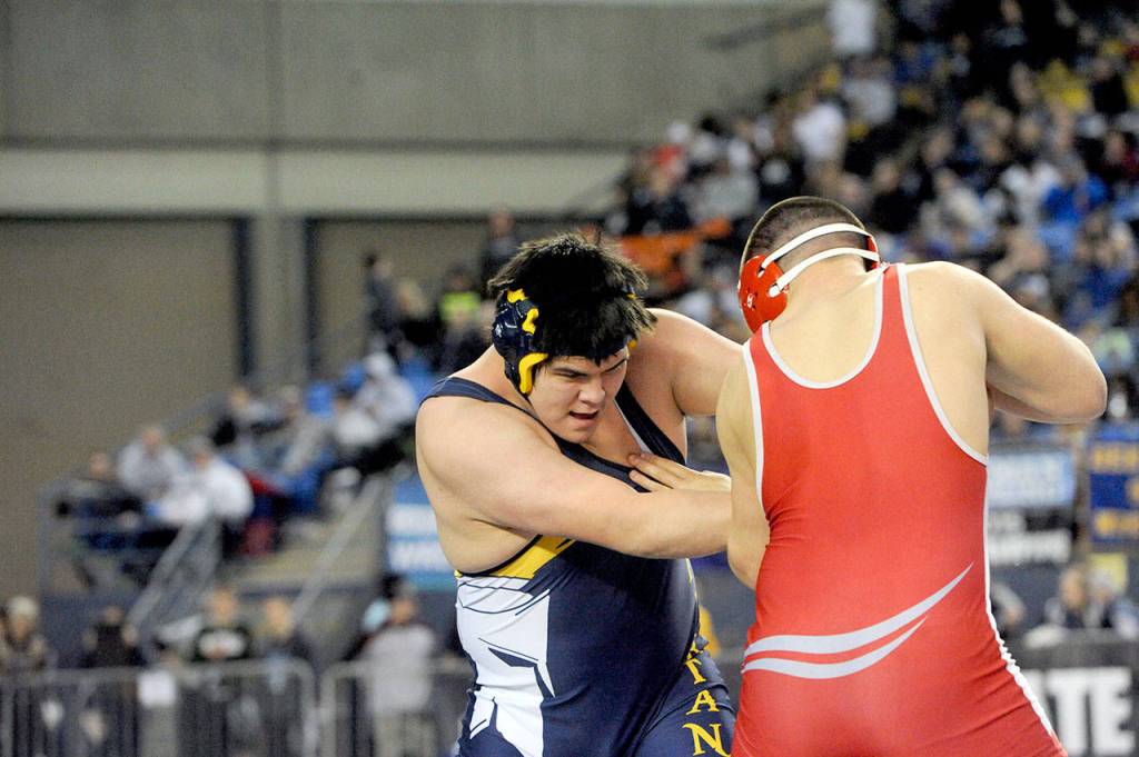 Lonnie Archibald/for the Peninsula Daily News Forks Nate Flores wrestles Arthur Drake of Cascade (Leavenworth) in a 285-pound match at Mat Classic, the state wrestling tournament, Flores reached the semifinals but suffered an injury and was forced to forfeit his final three matches and placed sixth.