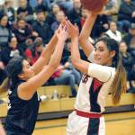 Keith Thorpe/Peninsula Daily News                                Neah Bays Courtney Swan, right, fends off Lummis Janyha Ell during their Tri-District playoff game Feb. 13 in Port Angeles.