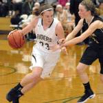 Keith Thorpe/Peninsula Daily News Port Angeles Jaida Wood, left, drives past Sequims Abby Schroeder during their Dec. 13, game in Port Angeles.
