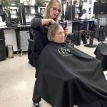 Shara Smith, owner of The Hair School in Port Angeles, talks with Dawn Saiz about the type of wig shed like as part of an Olympic Medical Center and American Cancer Society program providing free wigs to women undergoing cancer treatment. (Fran Howell/for Peninsula Daily News)