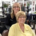 Cancer patient Dawn Saiz of Sequim with her new wig, styled by Shara Smith, owner of The Hair School in Port Angeles. (Fran Howell/for Peninsula Daily News)