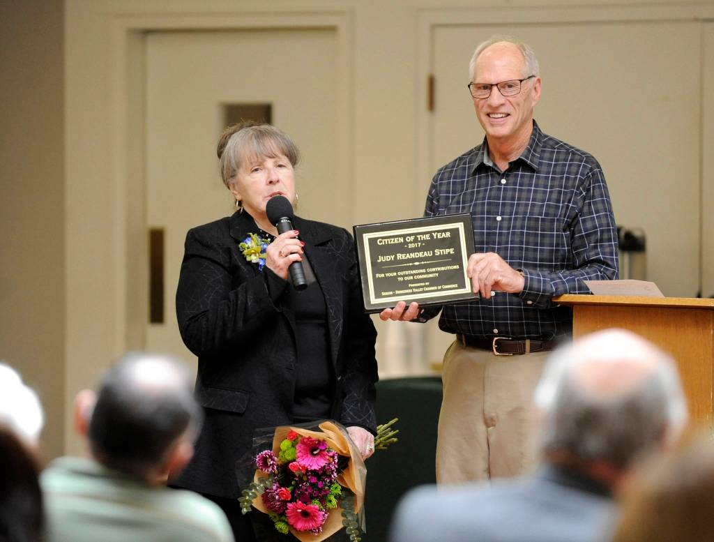 Michael Dashiell/Olympic Peninsula News Group                                Judy Reandeau Stipe accepts her Sequim-Dungeness Valley Chamber of Commerce 2017 Citizen of the Year award from award committee chair Bill Littlejohn on Tuesday.