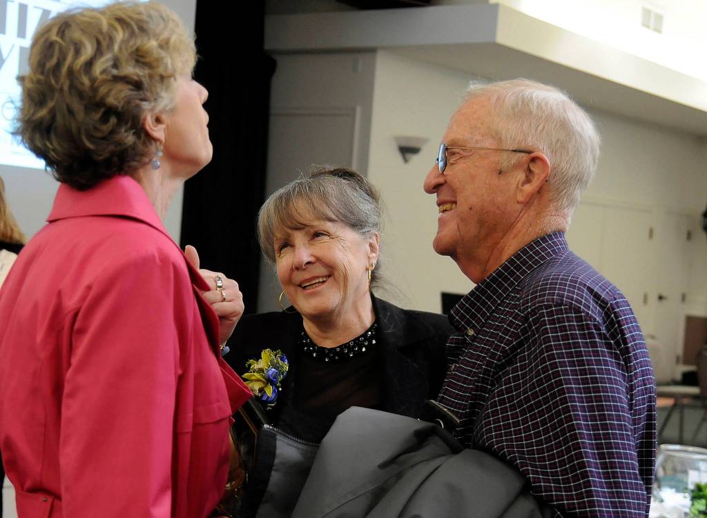 Judy Reandeau Stipe, center, shares a laugh with Nell Clausen and Gary Smith following the Sequim-Dungeness Valley Chamber of Commerce Citizen of the Year luncheon on Tuesday. (Michael Dashiell/Olympic Peninsula News Group)