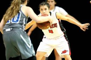 David Willoughby/for Peninsula Daily News                                Neah Bays Laila Greene (4) eyes Mount Vernon Christians Josie Droog during the Red Devils 53-34 Class 1B state quarterfinal win over the Hurricanes at Spokane Arena on Thursday.