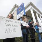 Port Angeles High School students, from left, Gillian Elofson, 17, Charlotte Hertel, 16, Darbey Martin, 17, and Emily Menshew, 17, protest outside a gun and knife show at the Port Angeles Masonic Temple calling for gun control on Sunday. The students said there will be a walkout at Port Angeles High School on March 14 at 10 a.m., lasting 17 minutes. Those 17 minutes represent the 17 people killed at a high school in Florida last month. (Jesse Major/Peninsula Daily News)