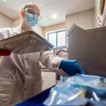 Mischa Levis, a medical and dental assistant at Volunteers in Medicine of the Olympics (VIMO), sterilizes dental equipment. (Jesse Major/Peninsula Daily News)
