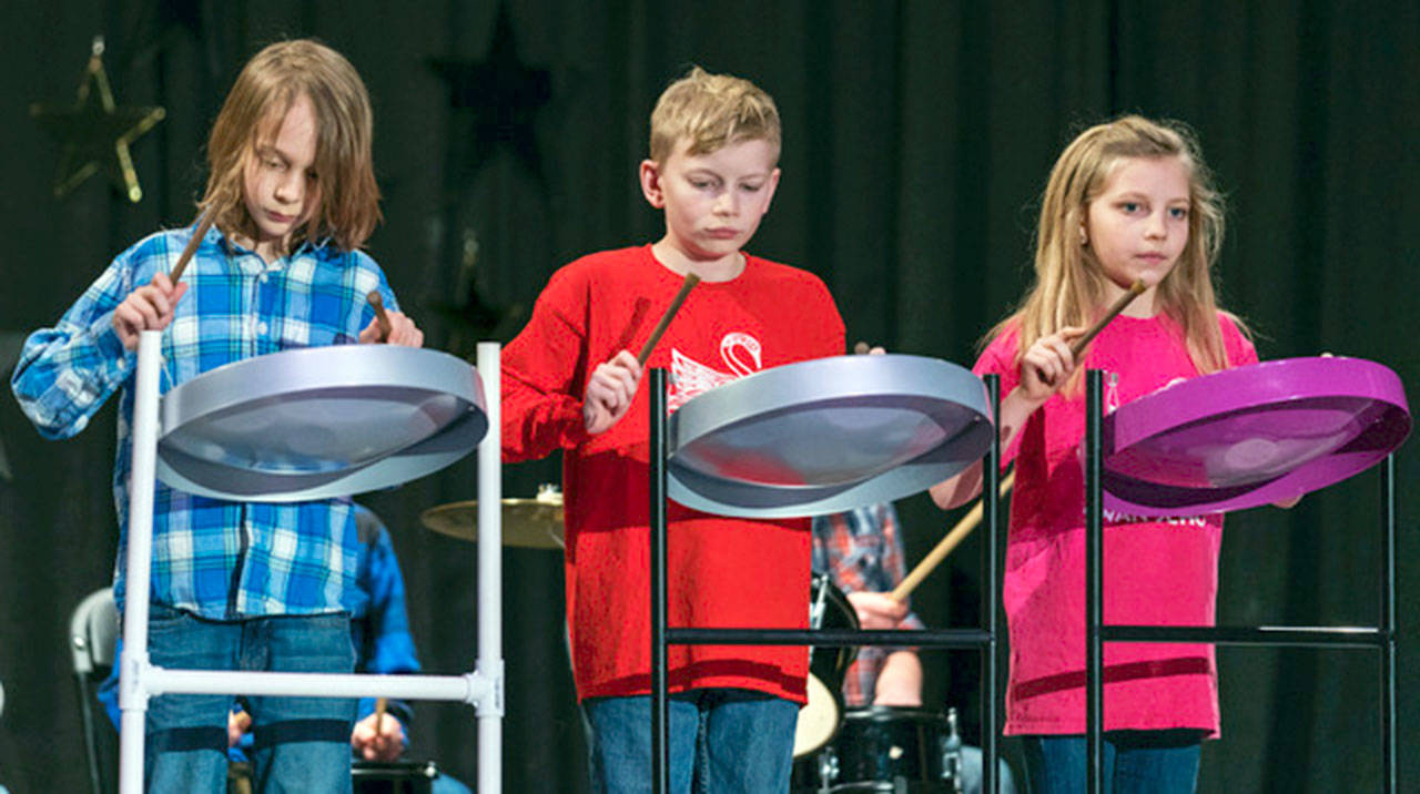 From left, Swan School steel pan, marimba and percussion ensemble members Luci Sarti, Ezra Lewis and Ziva Lewis. (Swan School)