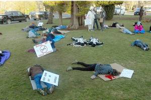 Demonstrators take part in ‘Die in — Lie in’ at Friends of the NRA fundraiser in Port Angeles